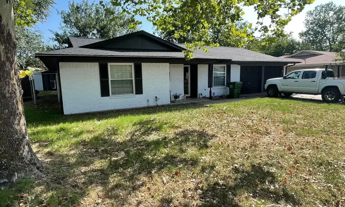 Professional roofing crew working on a residential roof in Dennis